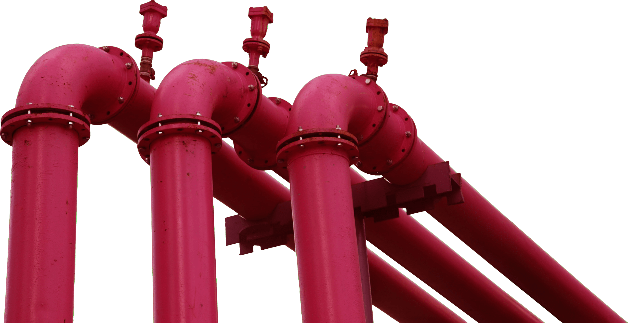 Bright pink industrial pipes with valves, showcasing a segment of a piping system, highlighting infrastructure in a manufacturing context.